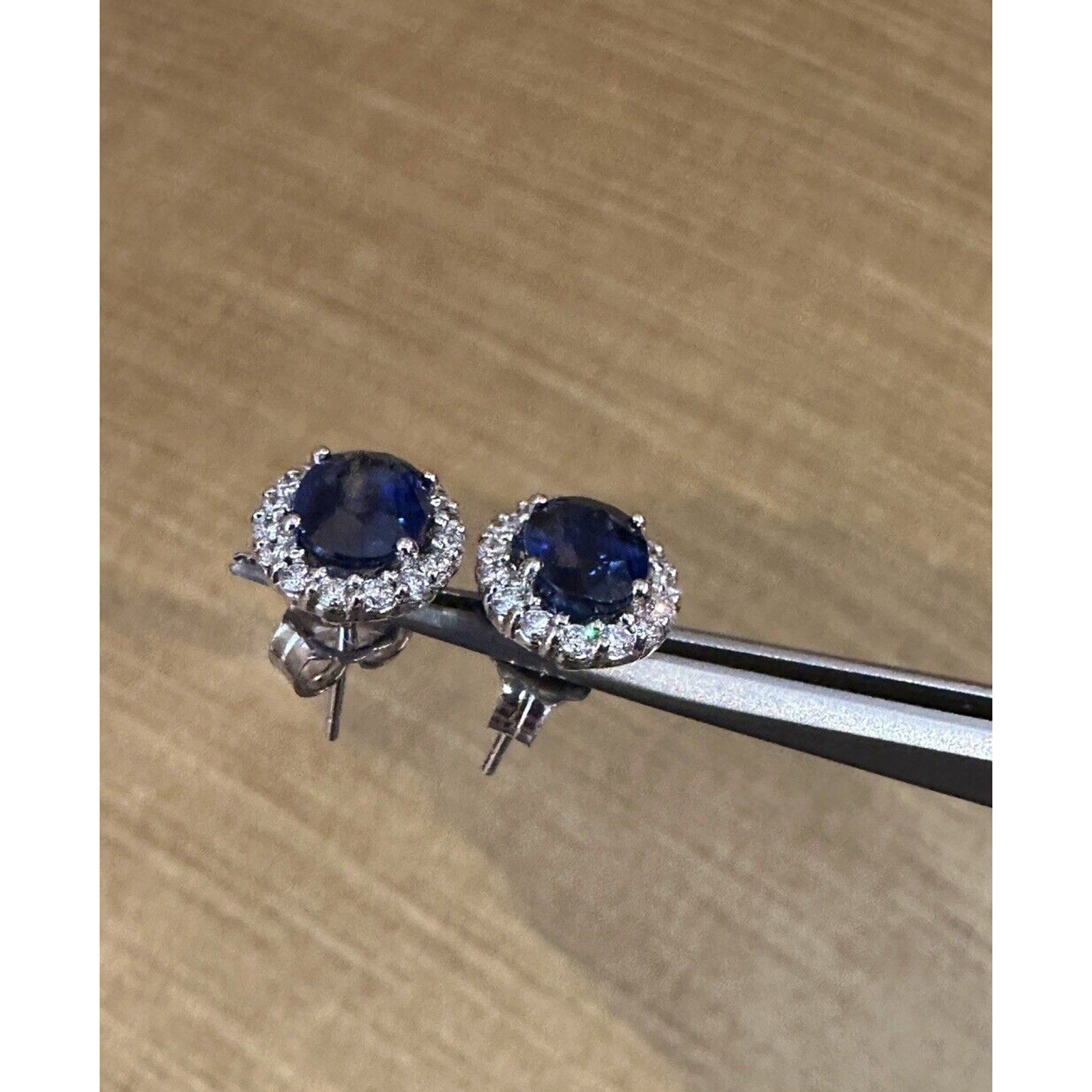 Oval Blue Sapphire and Diamond Halo Earrings in 14k White Gold