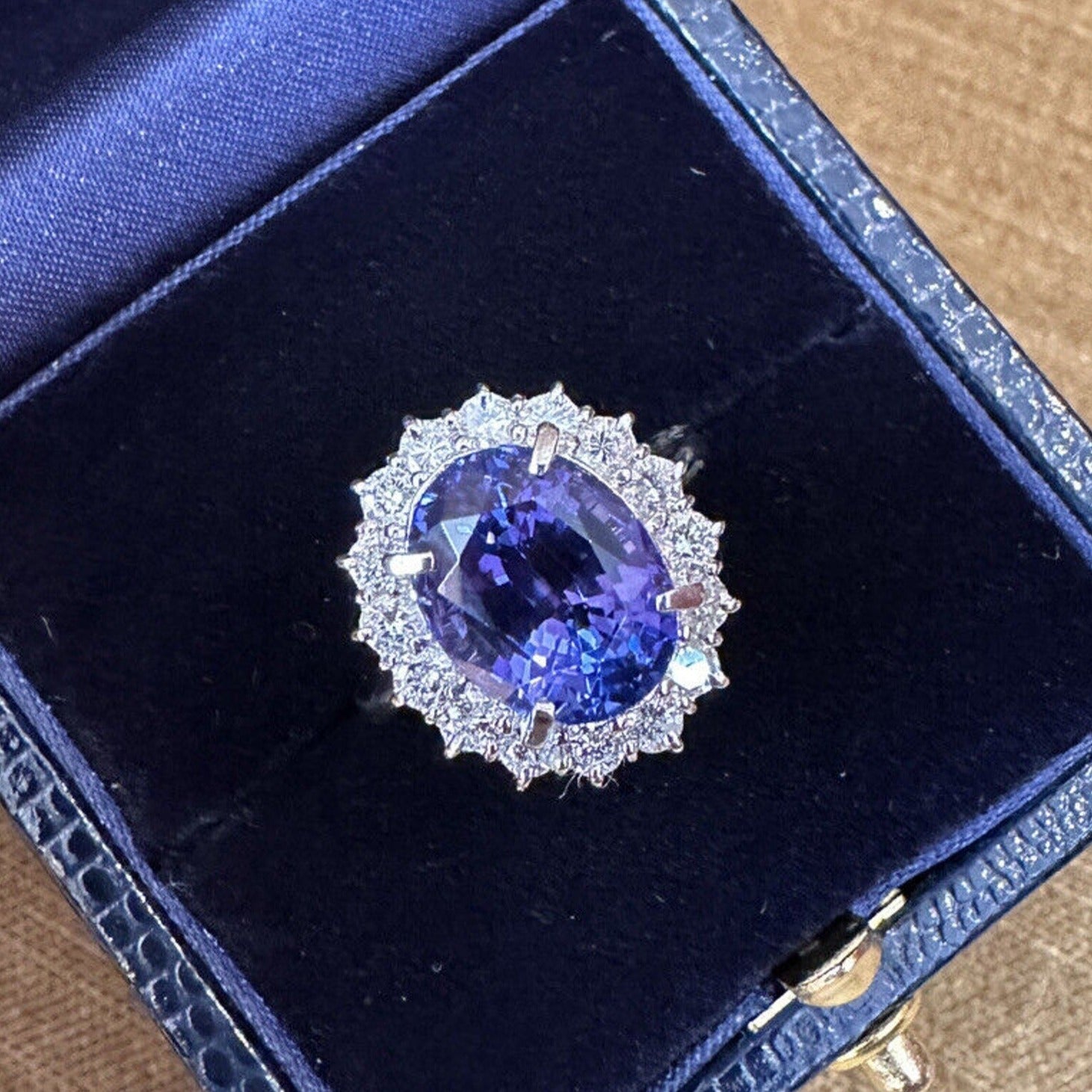 Estate 6.63 carats Oval Tanzanite Ring with Halo Diamond in Platinum