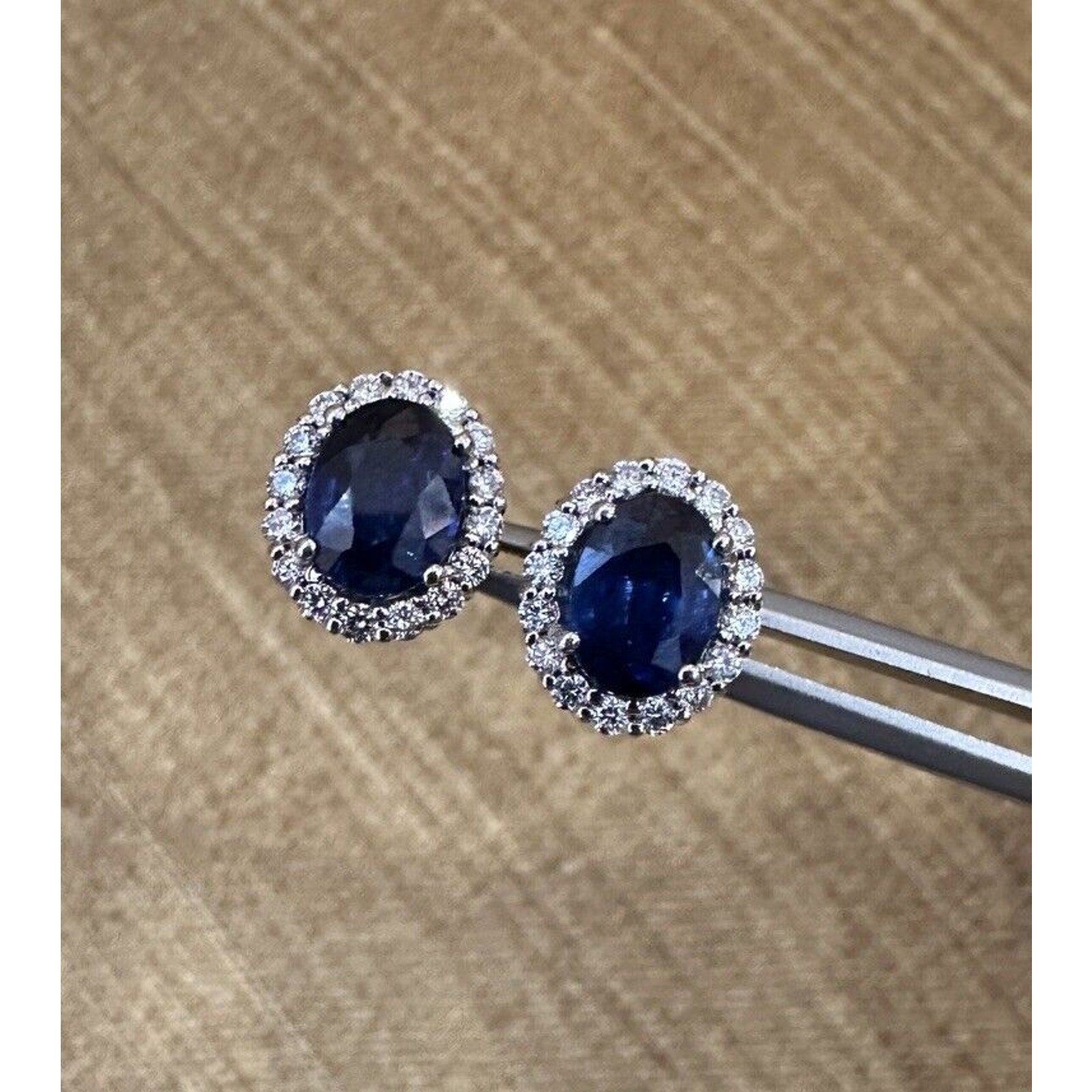 Oval Blue Sapphire and Diamond Halo Earrings in 14k White Gold