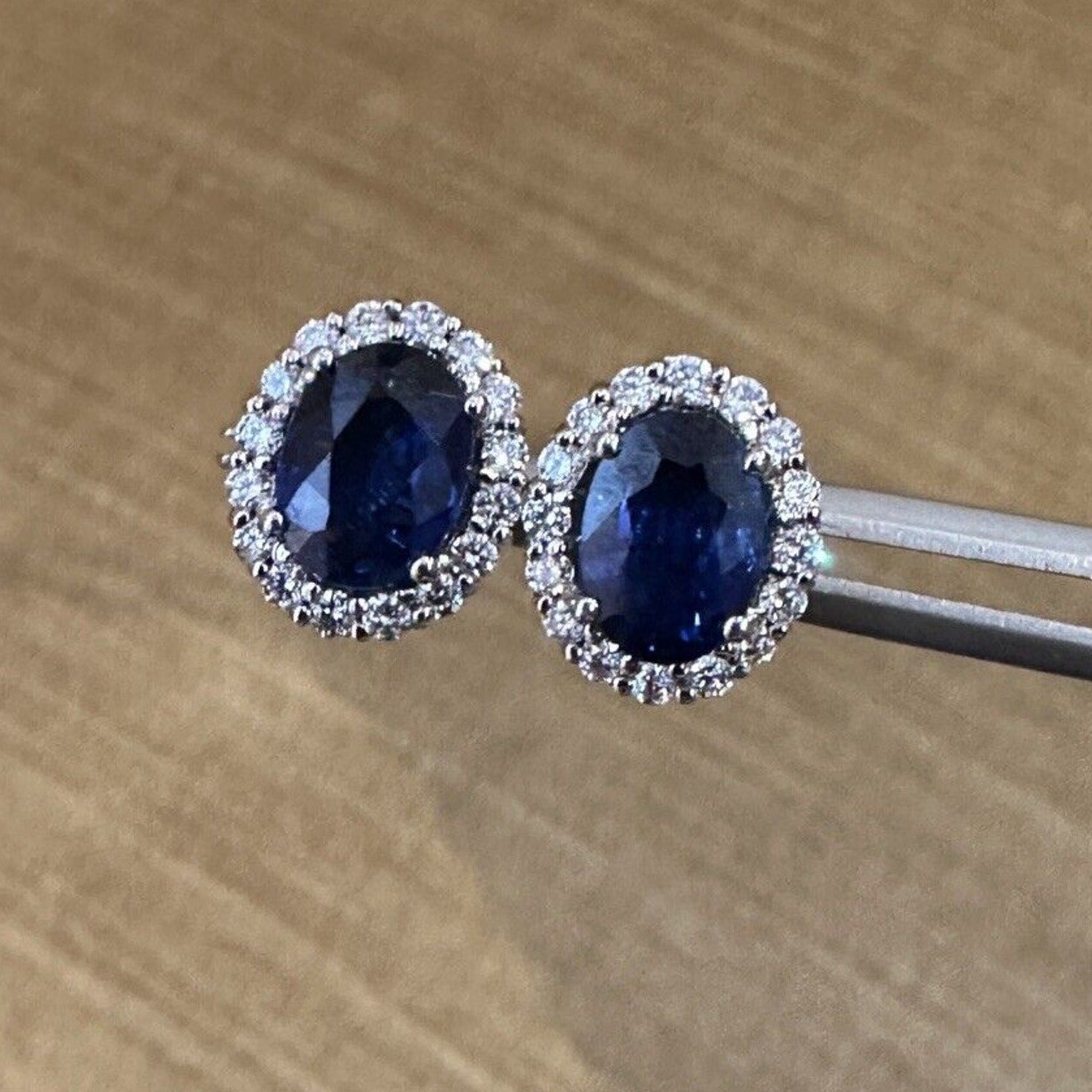 Oval Blue Sapphire and Diamond Halo Earrings in 14k White Gold